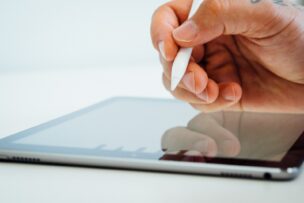 person holding white stylus pen